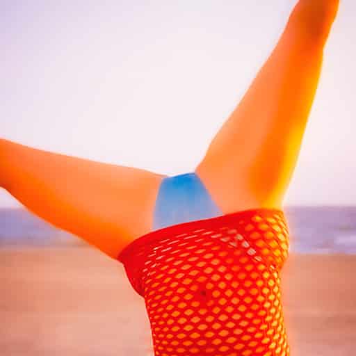 Woman does cartwheel on beach after waxing for smooth bikini lines